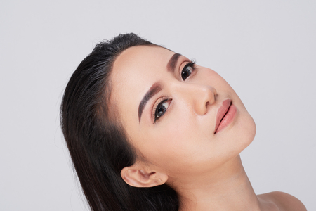 Beautiful Young Woman(Asian girl 20-30 years old) with clean fresh skin on white background.の写真素材