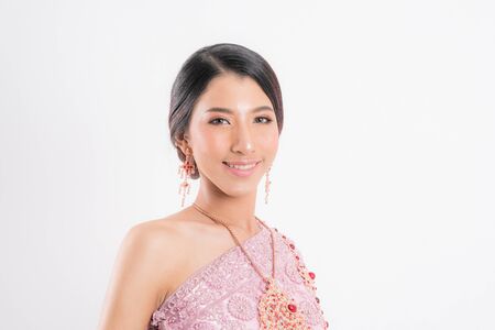 Beautiful make up portrait thai woman wearing typical traditional at studio shot isolated on white background.の写真素材
