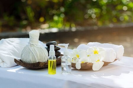Beautiful spa composition on massage white table at outdoors.の写真素材