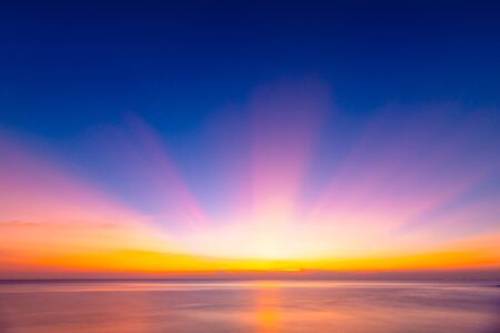 Beautiful background sunrise or sunrise sky with sunbeam over the sea. Copy spaceの写真素材