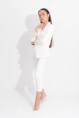 Asian business woman wearing white work suit are standing strive, looking at the front  isolated on white background and shadow.の写真素材