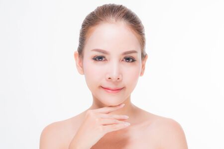 Beautiful young woman with clean fresh skin, Hair sleek, Proposing a product. Gestures for advertisement on pink background, Front view, with copy space.の写真素材