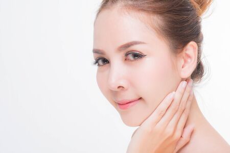 Beautiful young woman with clean fresh skin, Hair sleek, Proposing a product. Gestures for advertisement on pink background, Front view, with copy space.の写真素材