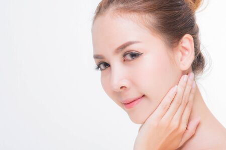 Beautiful young woman with clean fresh skin, Hair sleek, Proposing a product. Gestures for advertisement on pink background, Front view, with copy space.の写真素材