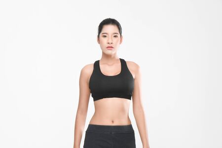 Shapely woman long hair wearing black fitness clothes in a series of exercises isolated on white background.の写真素材