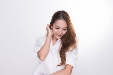 Asian woman portrait with perfect skin and wearing a white shirt in profile isolated on gray background.の写真素材