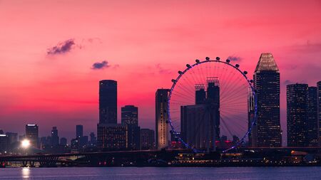 Marina bay at Singapore with Singapore skyscraper on background in evening time with sunset light.の写真素材