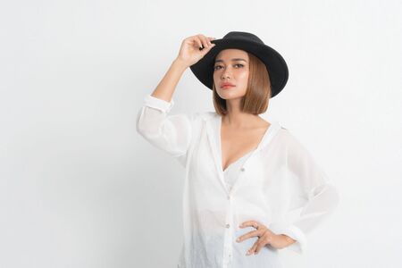 Beautiful portrait asian woman brown short bob wearing black hat and white shirt in stand position with fashion on isolated white background.の写真素材