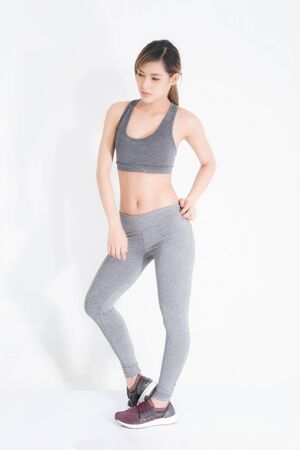 Sporty girl of fitness model isolated on white background. Sport and healthy lifestyle.の写真素材