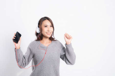 Beautiful asian woman with long brown hair wearing white shirt and black bra, sexy fashion position studio shot isolated on gray background.の写真素材