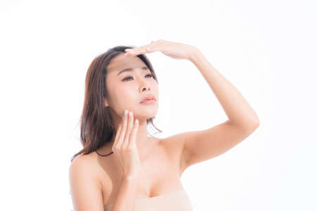 Beautiful asian woman with long brown hair wearing white shirt and black bra, sexy fashion position studio shot isolated on gray background.の写真素材
