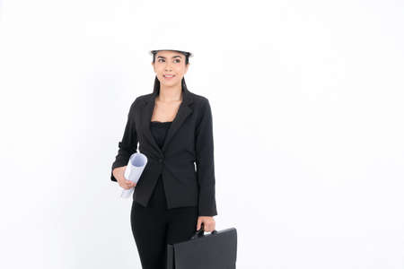 Portrait young engineer woman is submitting ideas about plans and projects, while holding blueprints and a pen in hand at shot studio isolated on white background.の写真素材