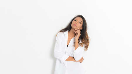 Portrait dark skinned beautiful woman with perfect skin wear white shirt casual clothing at studio shoot on white background.の写真素材