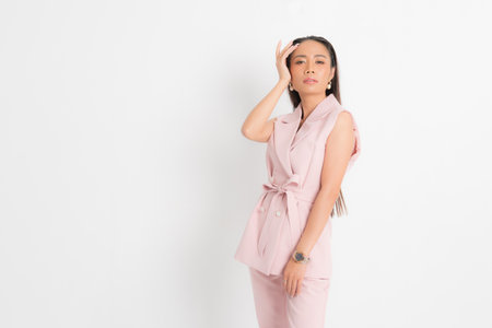 Fashion style catalog clothing for business woman black long hair natural make up wear pink suit costume perfect body shape suit at studio shoot on white background and shadow.の写真素材