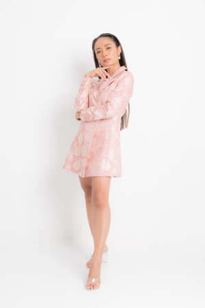 Fashion style catalog clothing for business woman black long hair natural make up wear pink dress costume perfect body shape suit at studio shoot on white background and shadow.の写真素材