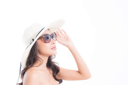 Close-up, Beautiful woman portrait face in sun hat and sunglasses enjoying with sun at studio shot isolated on white background. Sun protection concept.の写真素材