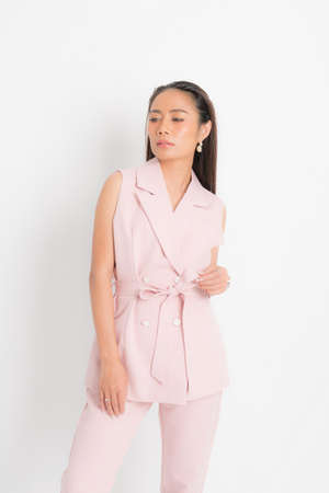Fashion style catalog clothing for business woman black long hair natural make up wear pink suit costume perfect body shape suit at studio shoot on white background and shadow.の写真素材