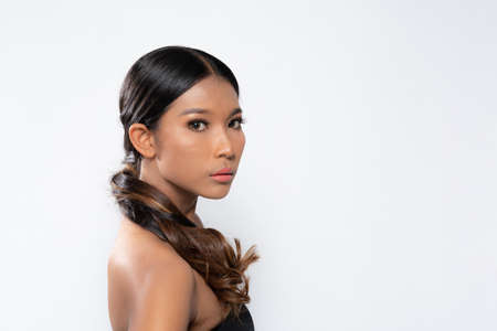 Beauty young dark skinned woman with perfect skin and Makeup. Bridal makeup delicate Pink tones, Wet make-up, shine. sexy lips. vivid pink makeup on white background. Close up shot.の写真素材