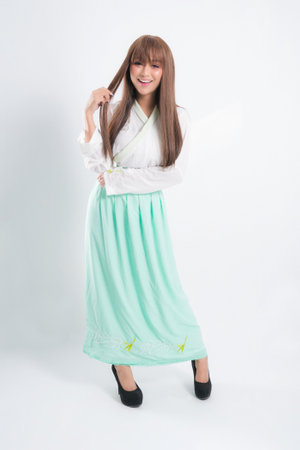 Korean woman wearing traditional korean dress on white background in studio. Beautiful Korea culture.の写真素材