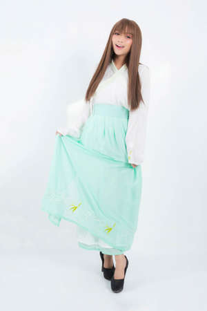 Korean woman wearing traditional korean dress on white background in studio. Beautiful Korea culture.の写真素材