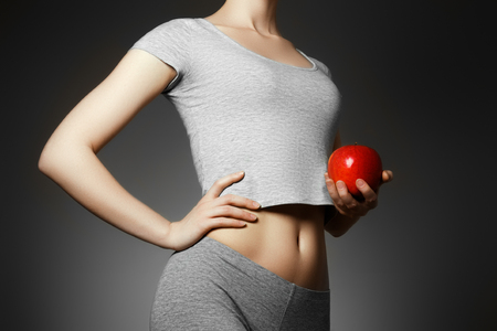 Beautiful fitness woman. Sporty girl showing her well trained bodyの写真素材