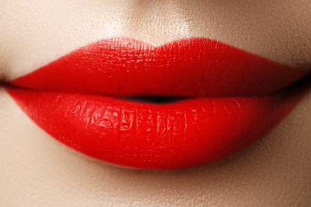 Close-up shot of woman lips with red lipstick. Beautiful perfect lips. Sexy mouth close up. Beautiful wide smile of young fresh woman with full lipsの写真素材