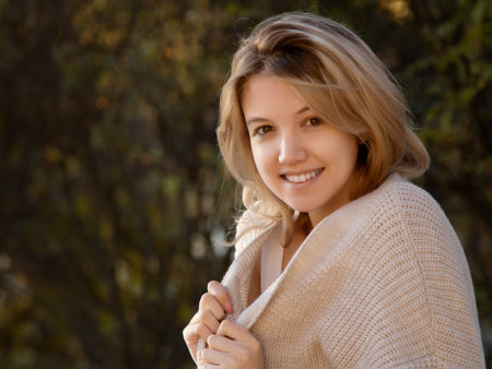 Excited happy fall woman smiling joyful outside in colorful fall forest. Beautiful Caucasian young woman. Beauty Smiling girl in autumn park. cute smiling girl looking at youの写真素材