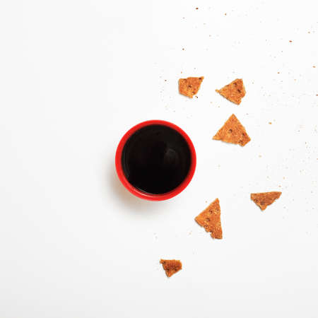 Minimalism. Red cup of coffee or tea among fresh healthy rusksの写真素材