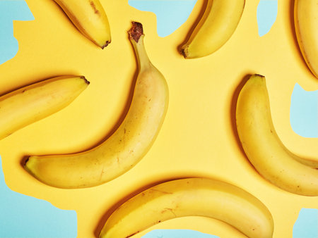 Bananas on an abstract yellow background. Flat lay. Top view