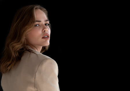 Natural look. Beauty model woman . Model test portrait with young beautiful fashion model posing on dark grey background. Blond woman in a biege blazer . Natural makeupの写真素材