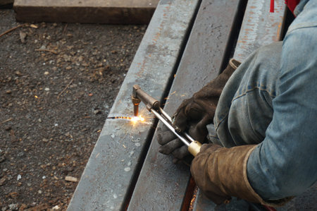 The worker is cutting metal by cutting torch