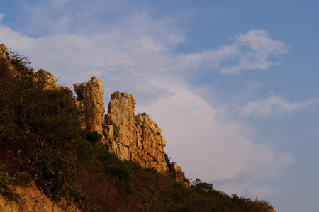 Closeup stone on hilltop with blue skyの写真素材