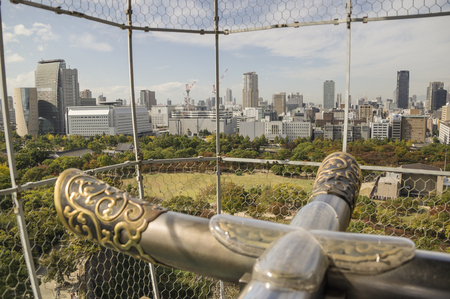 Osaka city view through to grille from Osaka castle, Osaka, Japan. Soft focus and blur imageのeditorial素材