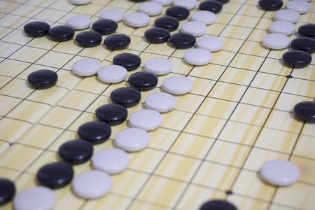 Close up of Go game while playing on board.の写真素材