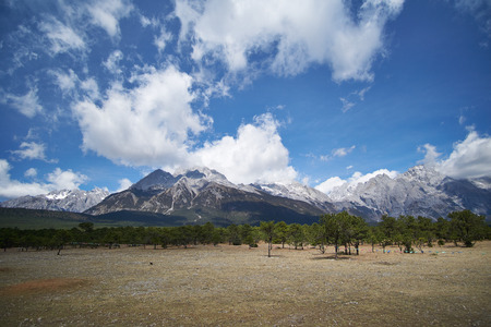 Landscape view of Jade Dragon Snow Mountain with blue sky and trees in bottom of mountain. It`s famous place in China for travel.の写真素材