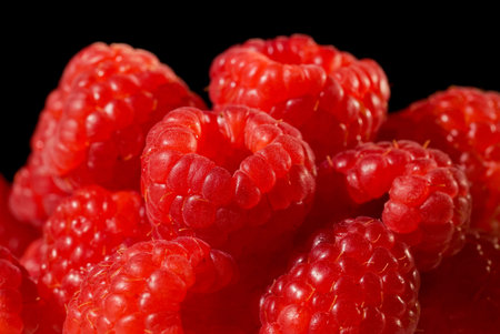 Raspberry on black background close up isolated