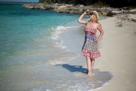 Young sexy blonde woman in beach dress near sea. Girl at the beachの写真素材