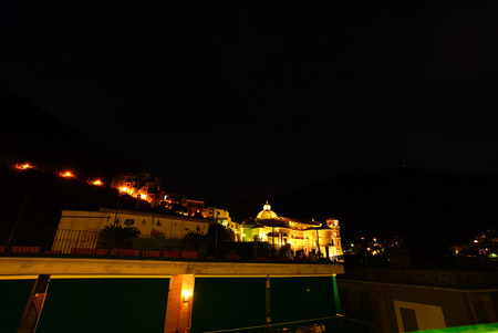 Small town or city in mountains in europe at dusk or nightの写真素材