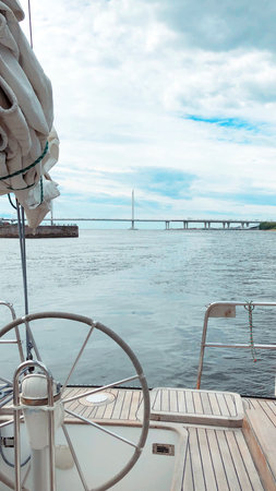Sailing in luxury sail yacht in a sea. Summer vacations. Young man.