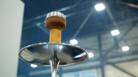 People choosing hookah. Smoking tobacco at exhibition. Shisha bowl at event