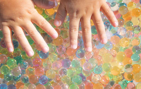 Colored balls of hydrogel touch childrens hands. Sensory sensations.の写真素材
