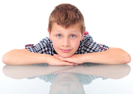 schoolboy leaning on school deskの写真素材
