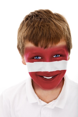 Young boy with latvia flag painted on his faceの写真素材