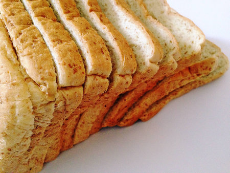 Fresh whole wheat bread placed on a white background.