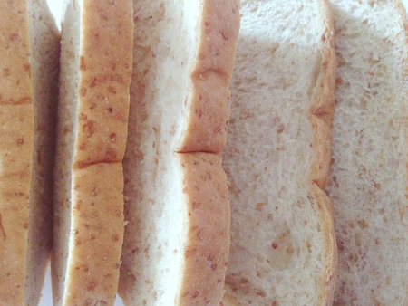 Fresh whole wheat bread placed on a white background.