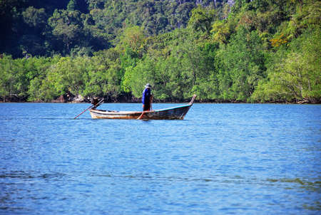 The vast river with wooden boats is sailing.の写真素材