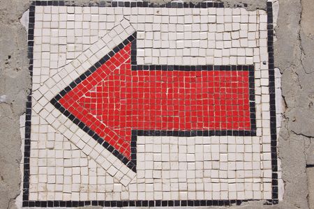 Red arrow with small stonesの写真素材