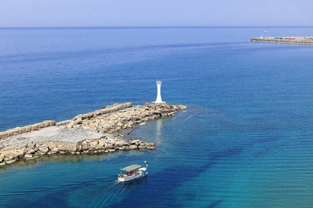 Lighthouse with boat in Girne in Northern Cyprusの写真素材