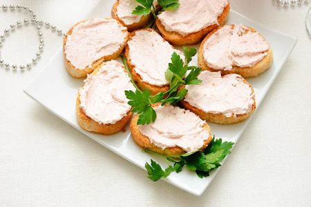 Snacks on a white plate on the festive tableの写真素材