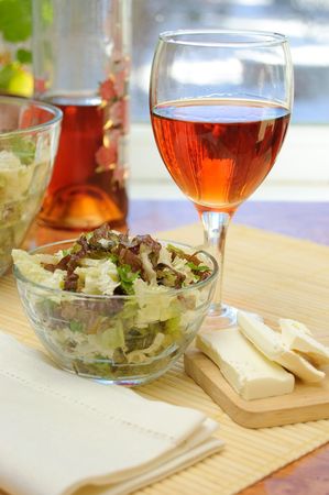 Fresh green salad in a transparent bowl on the kitchen tableの写真素材